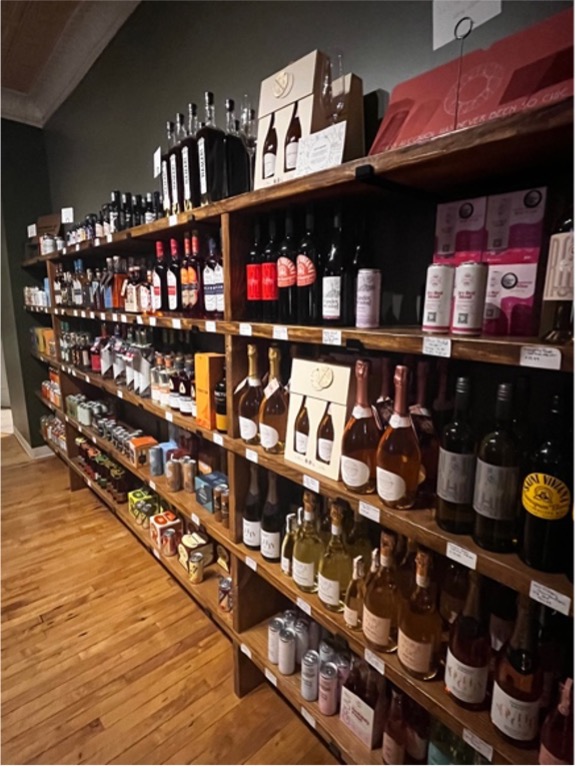 A wall of shelves holding liquor bottles.