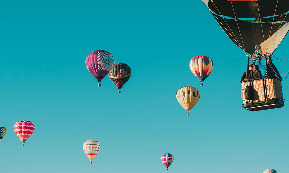 Multiple hot air balloons in the sky.