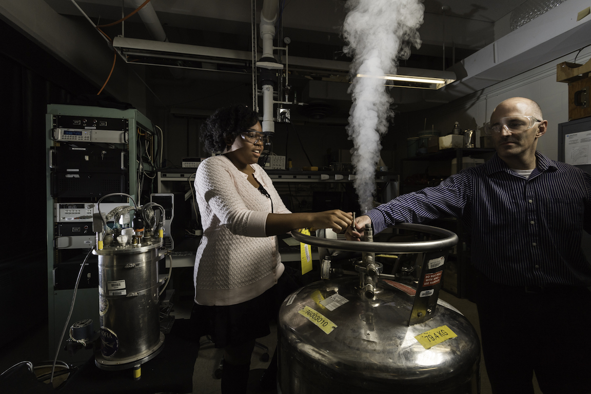 A student and professor in a lab.