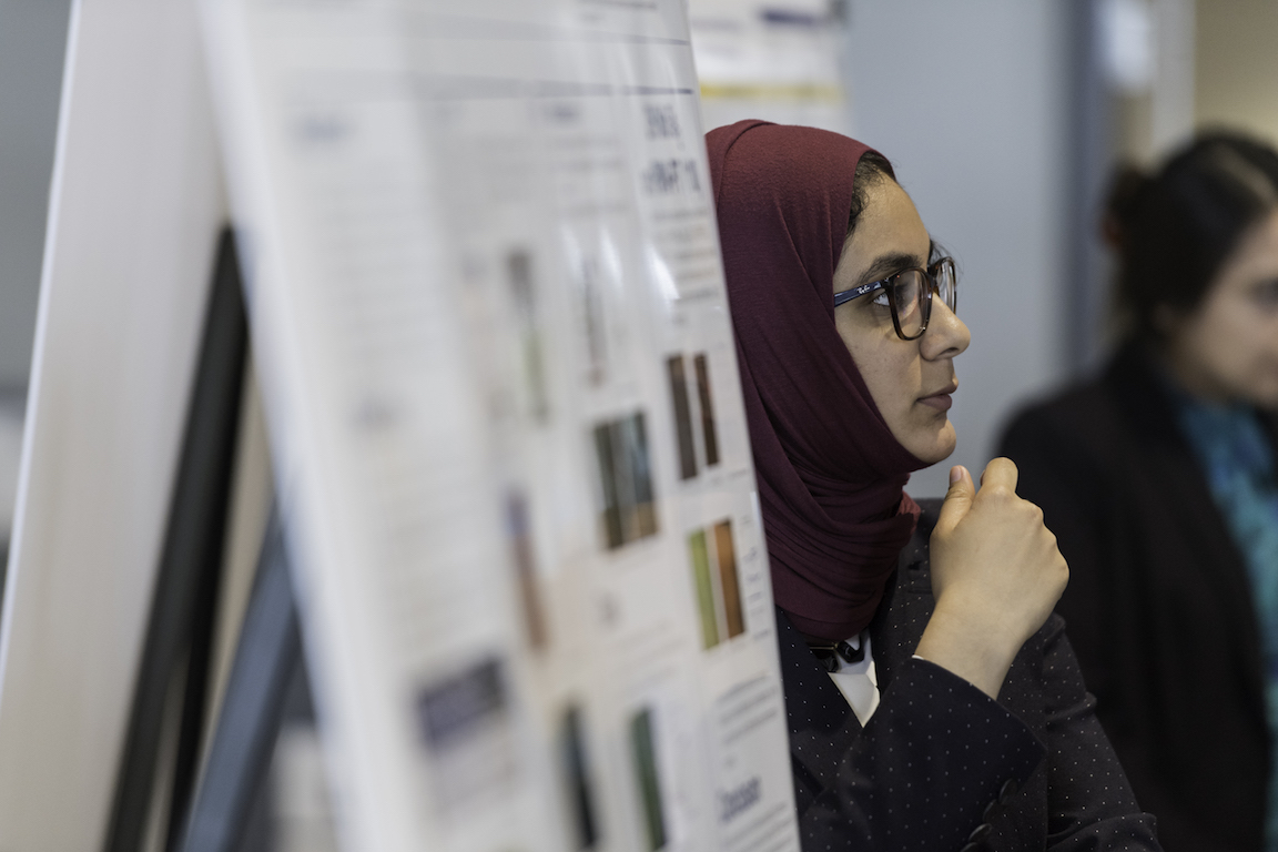 A student presenting a poster.