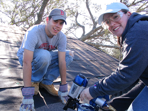 students repairing a roof