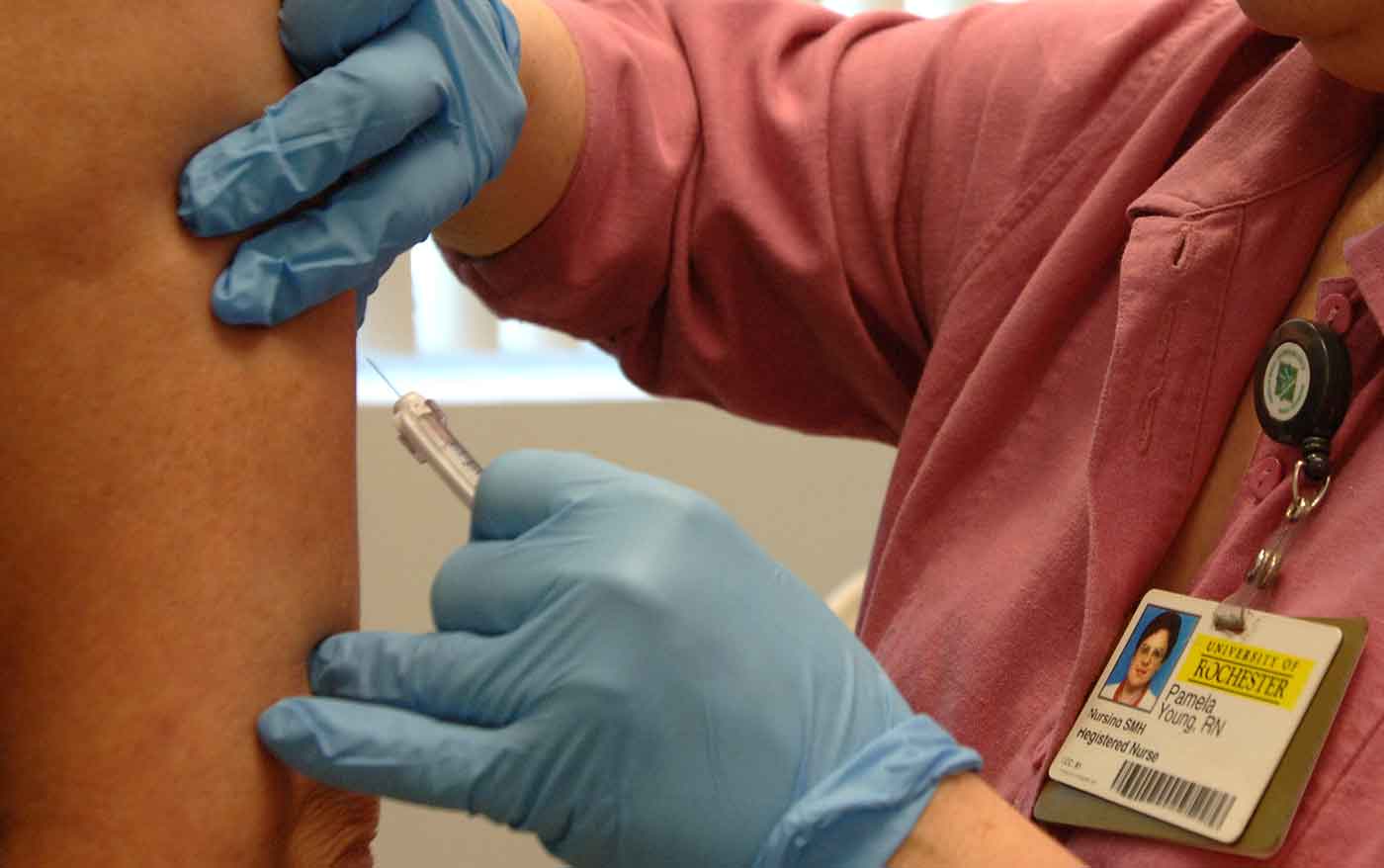 nurse giving injection to patient
