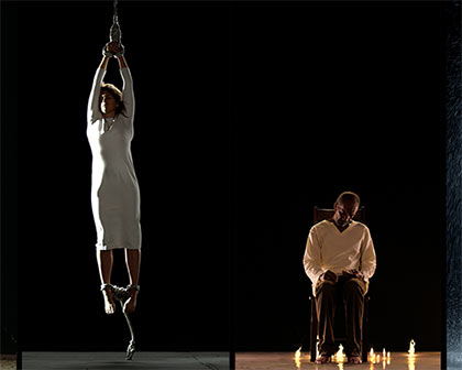man sitting by candles, woman suspended by ropes