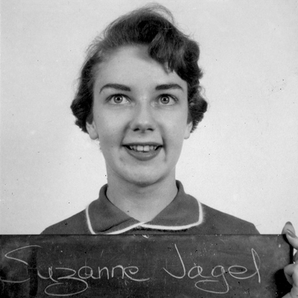 Suzanne holding a name plaque.
