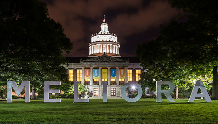 Meliora spelled out in from of Rush Rhees Library at night