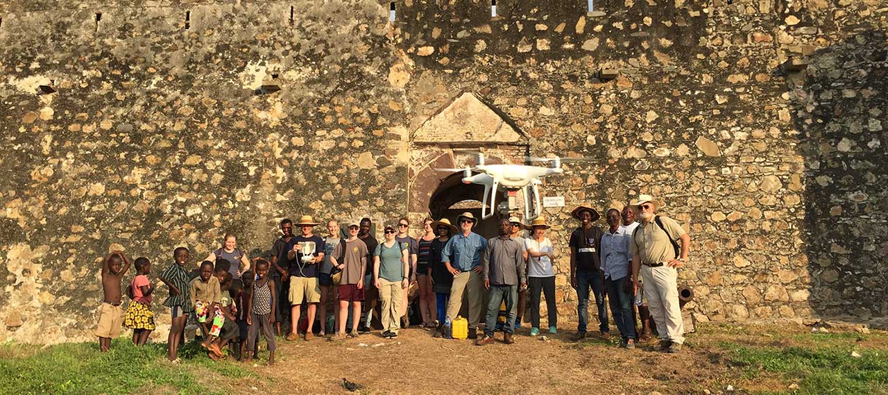 Group picture in front of wall