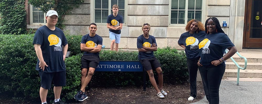 Peer advisors pose for the camera in front of Lattimore Hall.
