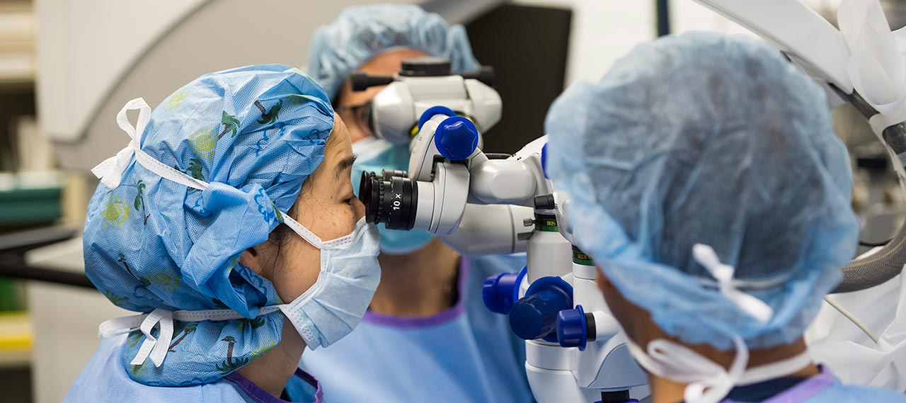 A doctor using a microscope.