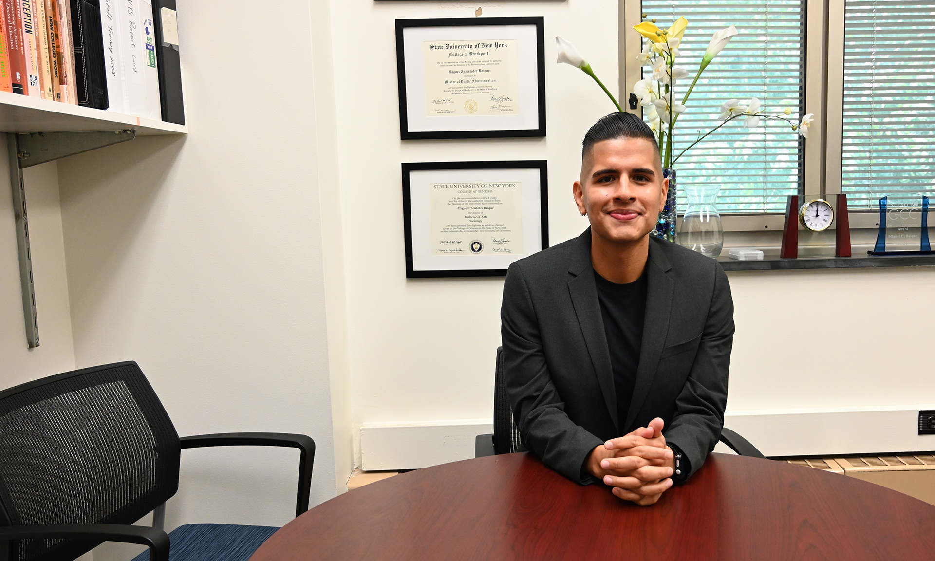 Dr. Miguel Baique sitting at a table in an office setting.