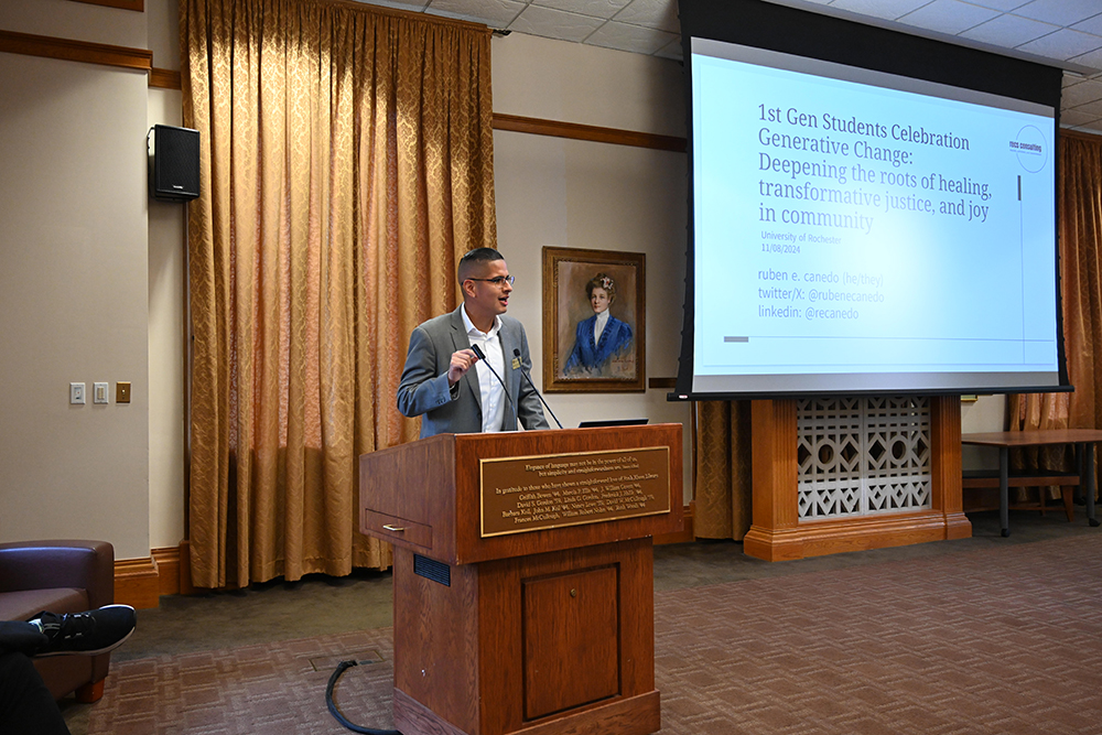 Dr. Baique speaking to a room while standing behind a podium.