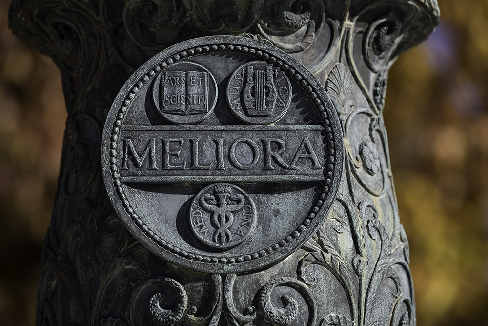 Meliora seal on flagpole base, Eastman Quad.