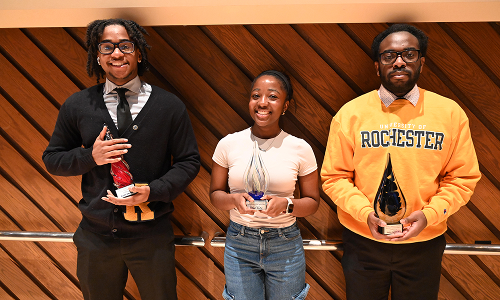 Three students holding awards.