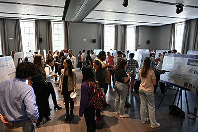 A group of University of Rochester students at a poster session.