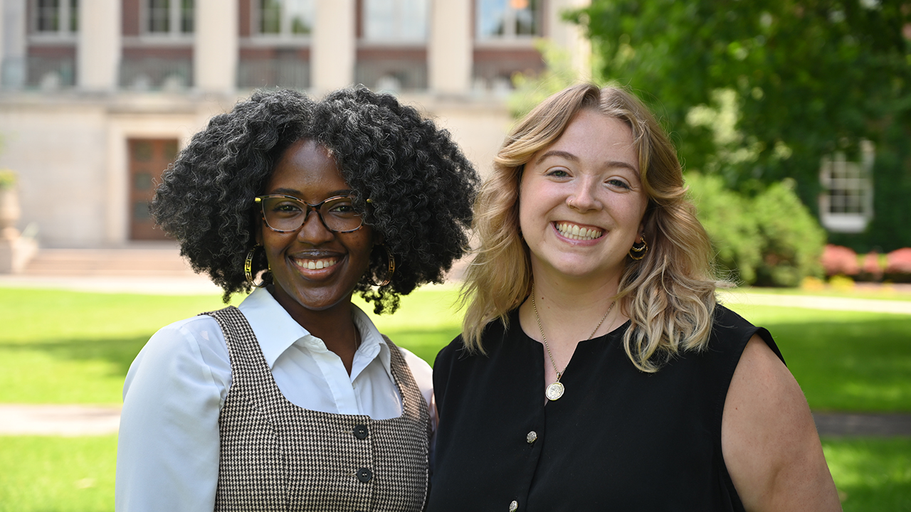 McCane and McCleary stand on the Eastman Quad outside Rush Rhees Library.