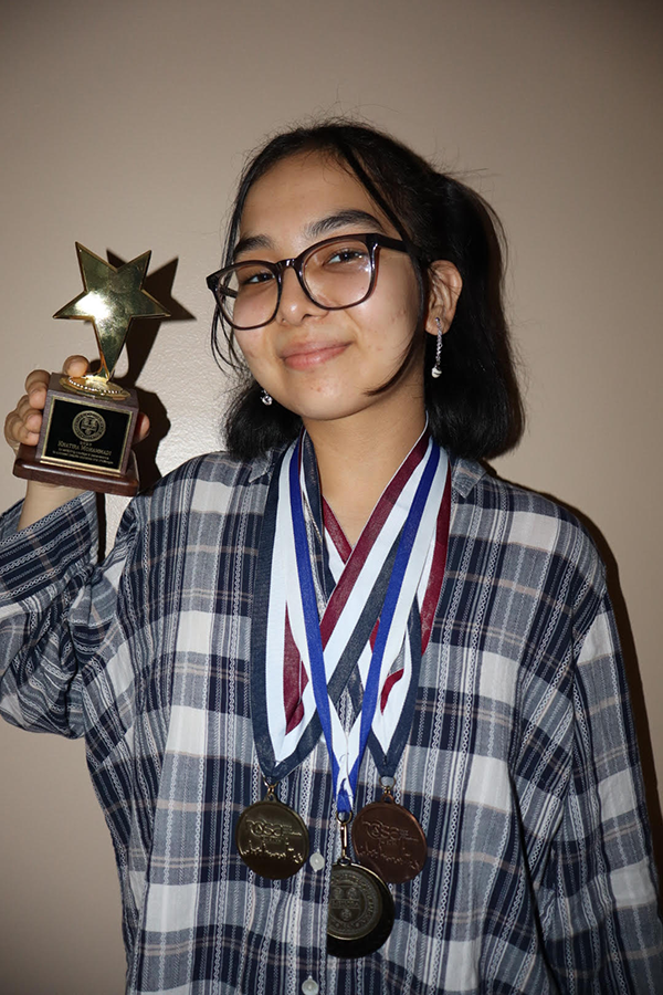 Khatira Mohammadi holding her medal.