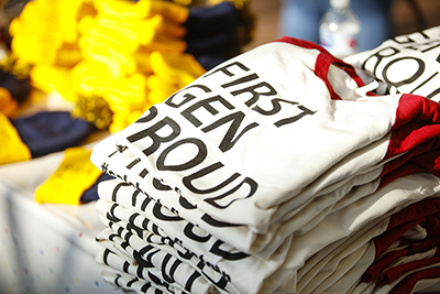 A stack of promotional t-shirts sitting on a table.