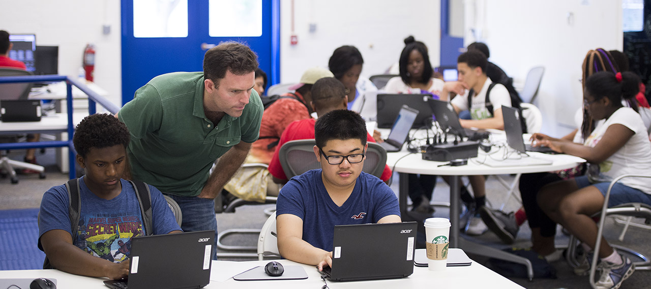 A professor helping students.