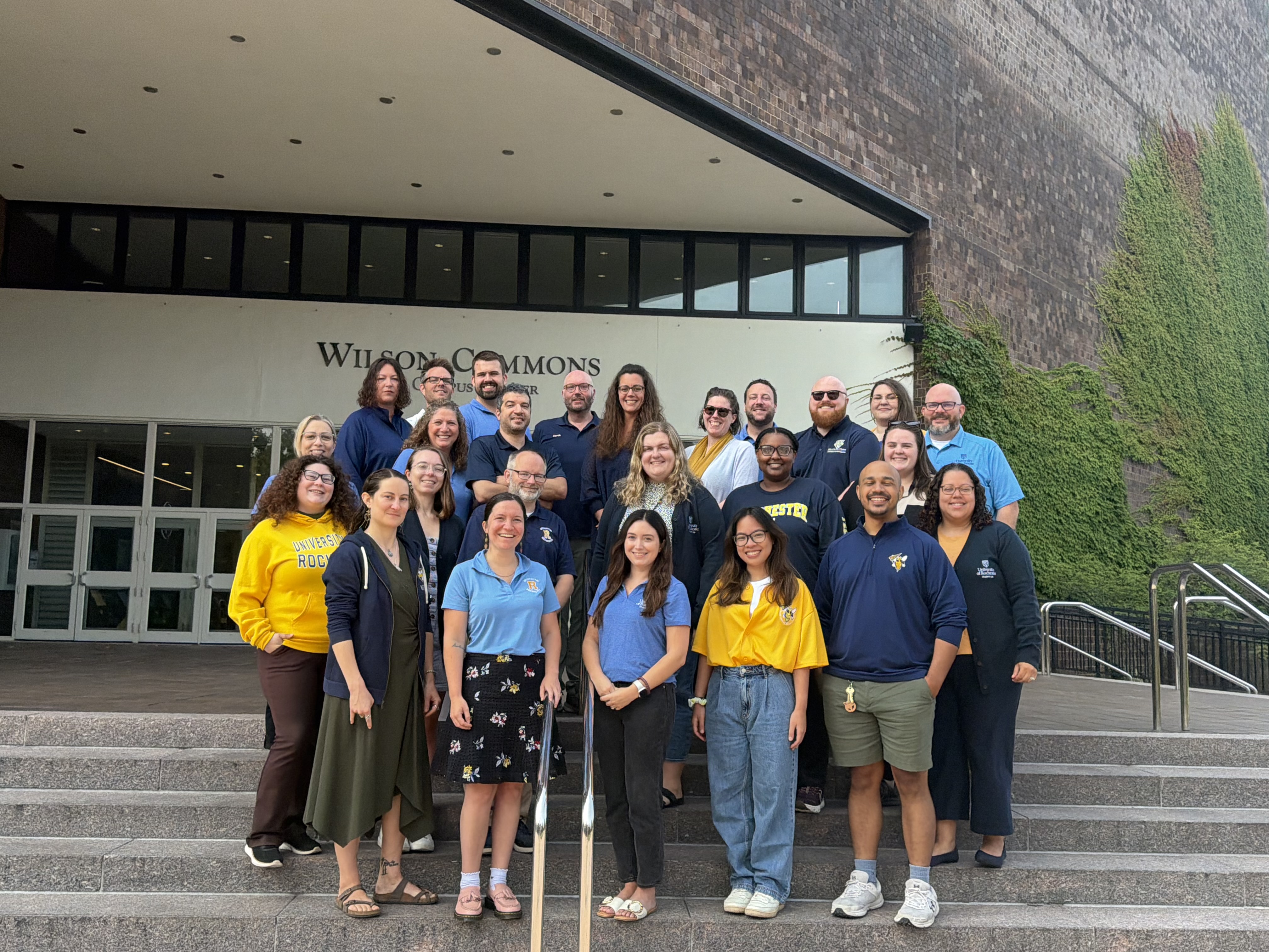 Office of the Dean of Students Staff Stands for a Group Photo outside Wilson Commons
