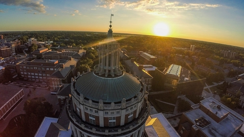 An exterior view of the top of Rush Rhees library at sunset.