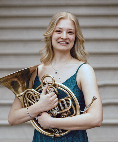 Headshot of Alina Liebschner holding a musical instrument.