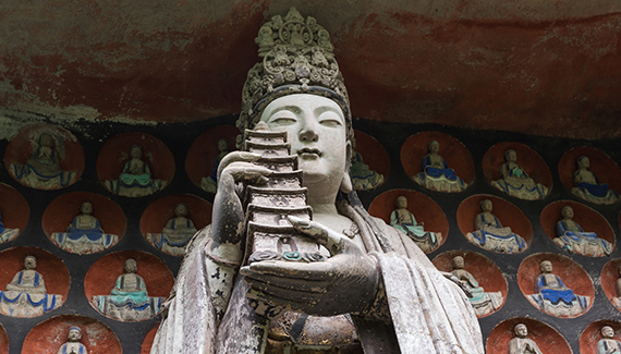 statue figure holds up pagoda