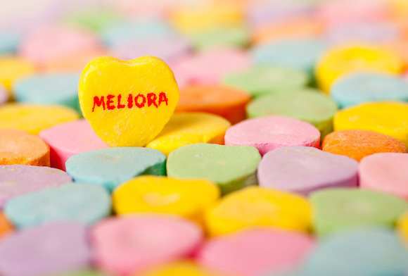 Colorful Valentine's day conversation hearts with a yellow heart bearing the word MELIORA