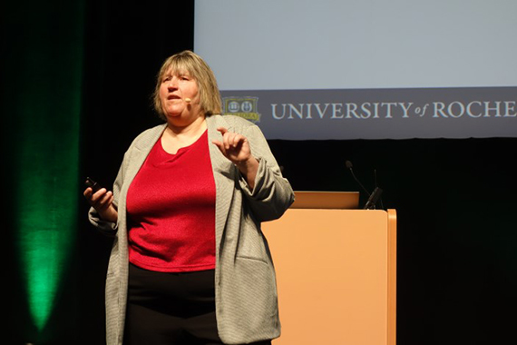 Julie Bentley speaks on stage in front of a lectern.