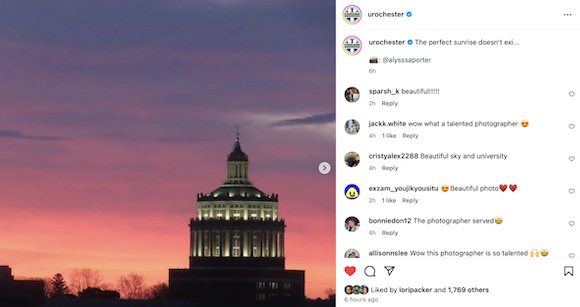 The sun rises over Rush Rhees Library