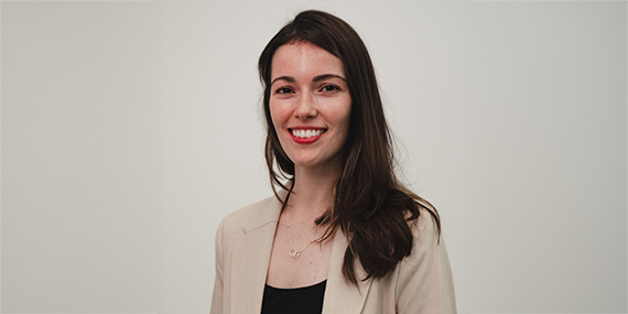 Portrait of Taylor Chartier against a gray background.