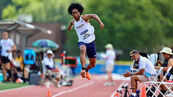 Cole Goodman leaps in the air while performing the triple jump at the NCAA Division III Outdoor Track & Field Championships.