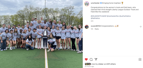 Track and field athletes holding championship trophy