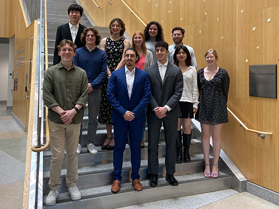 The newest inductees of Tau Beta Pi stand on the stairs in Goergen Hall.