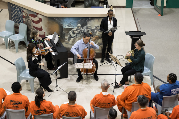 Small music ensemble performs for inmates in the rehabilitation unit at the Monroe County Jail