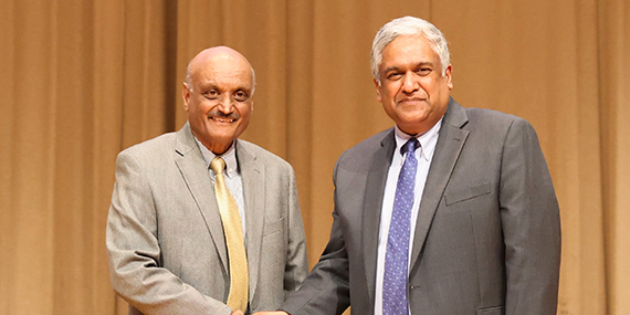 Bhaskar Pant (left) shakes hands with Anantha P. Chandrakasan (right).