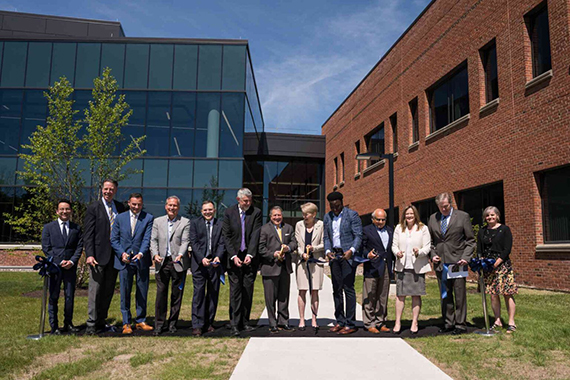 A group of dignitaries cuts the ribbon at the new Laboratory for Laser Energetics expanded facility.