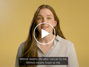 screenshot of youtube video with a woman in front of a light yellow background, with youtube play button