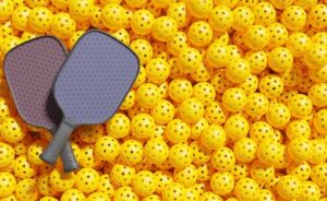 Pickball paddles on top of yellow pickballs