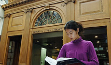 student reading outside Miner Library