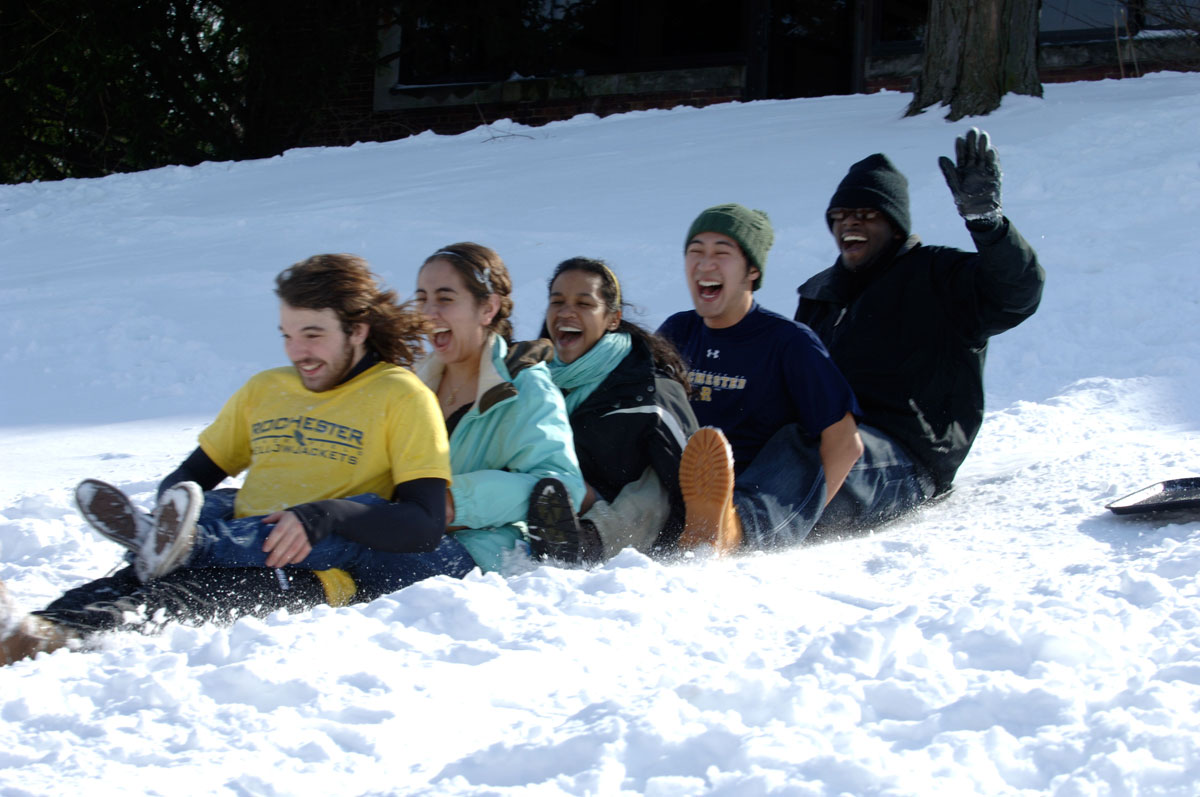 students sledding down a hill