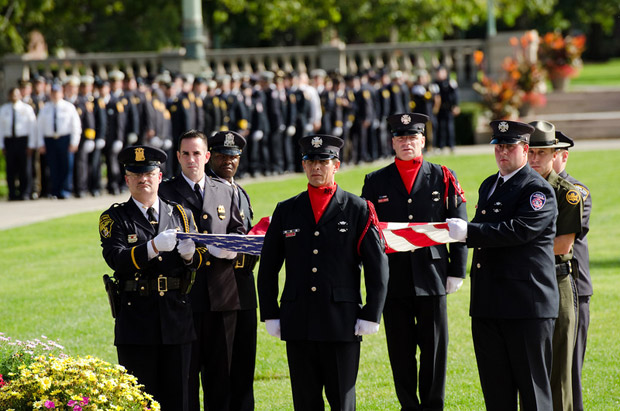 firefighters carry flag