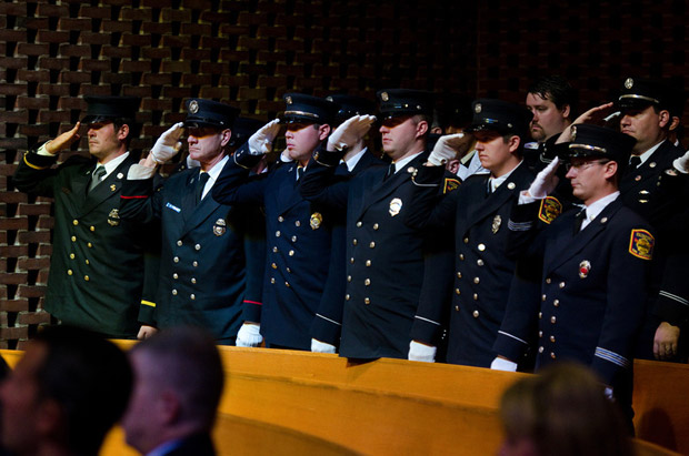 Firefighters and law enforcement officers salute