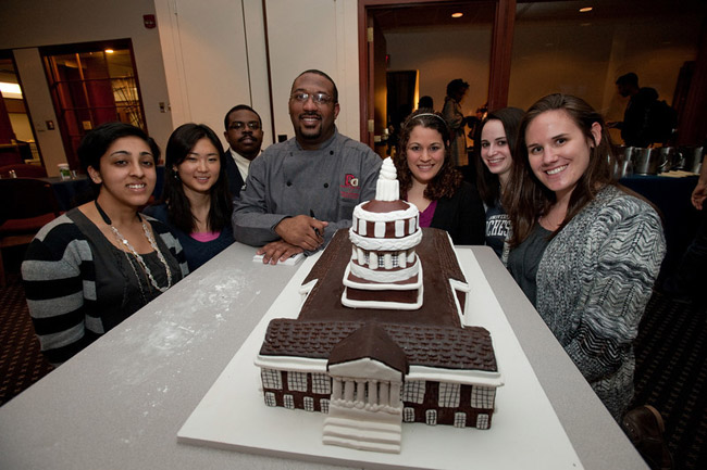 Dana Herbert poses with students and cake