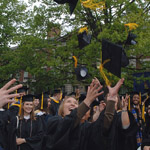 students throwing graduation caps