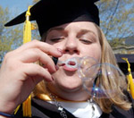 Student blowing bubbles at Commencement