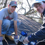 students repairing roof