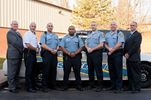 police officers standing in front of police car