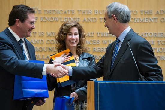 Rob Clark and his wifa Dana receive scarves as gifts from Joel Seligman