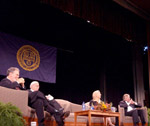 panel on stage at symposium