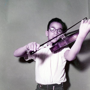 Paul Burgett as a child, playing the violin