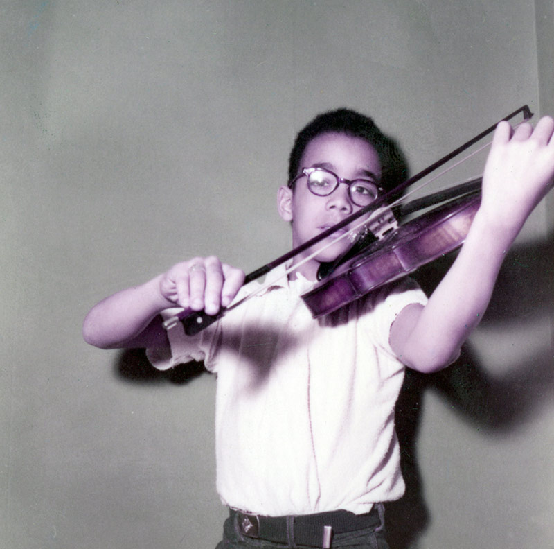 a young Paul Burgett plays the violin